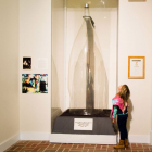 1992 a child staring up at the World's Largest Glass Bottle on display in the Museum of American Glass