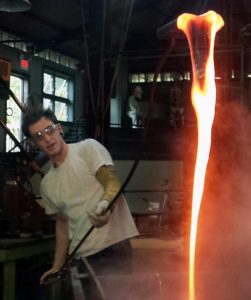Artist working on hot glass piece