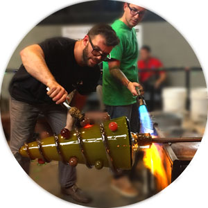 Two Glass artists shaping a large glass tree during Big Glass Blast.