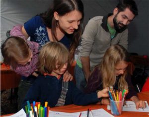Children coloring during Millville in May at WheatonArts