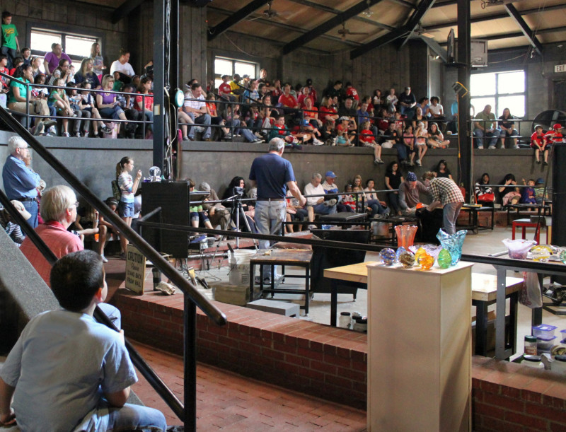 Large group of students watching a narrated Glass Studio demonstration