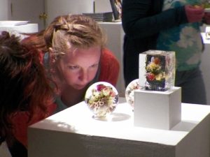 Paul Stankard's orb and botanical on display in The Gallery of Fine Craft