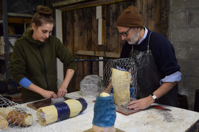 Helena and Charlie Parriott work together to create a mold