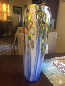 Tall glass vase by Joe Mattson with blue stripes and yellow spots running down the sides.