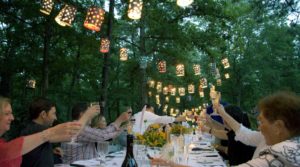 Group of people toasting wine glasses in celebration