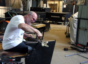 Artist working on glass piece