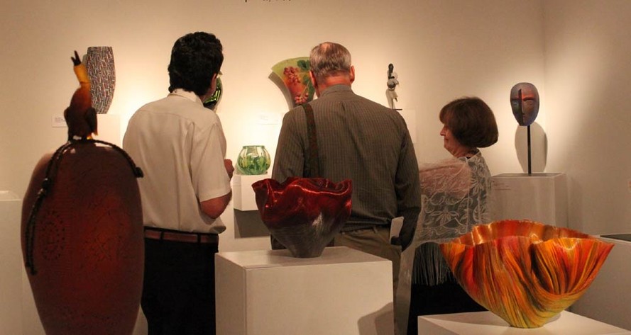 Patrons observing gallery exhibition during Glassweekend
