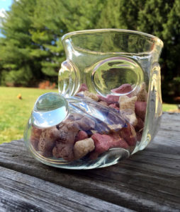 Glass dog treat container in the shape of a cartoon dog head