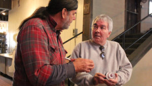 Two artists discussing glass piece
