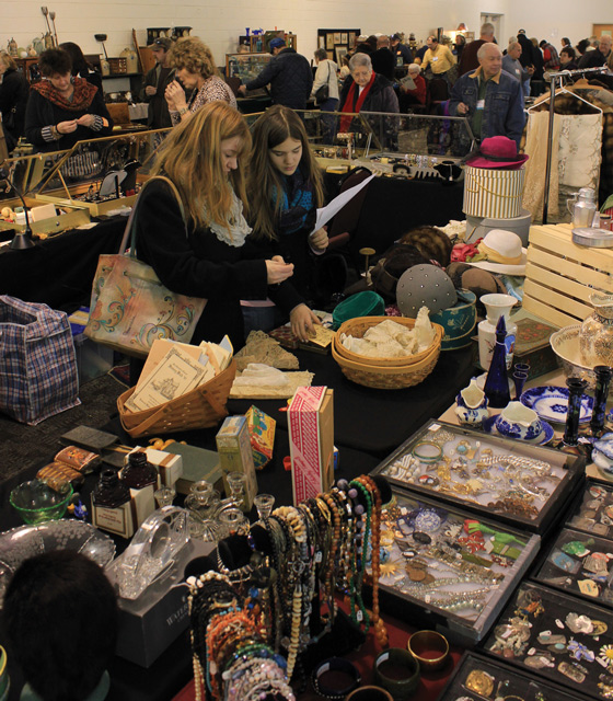 Visitors observing booths during the Mid-Winter Antiques Show