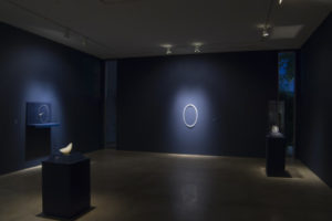 “L'heure bleue” installation view showing Une petite pipe morte (A Little Pipe Death), Pneu vélo verre (Glass Bicycle Tire), and Air amusé (Amused Air)