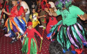 Group photo of children and adults dancing in Multi Colored Long Skirts