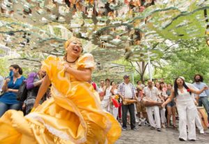 Woman in yellow dress in front of crowd