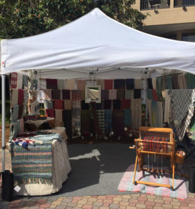 Booth showcasing the fiber work of Pauletta Berger