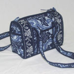Indigo blue bag with two straps, decorated with floral patterns.. Created by Shengzhu Bernardin