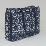 Quilted indigo blue bag with floral patterns, created by Shengzhu Bernardin
