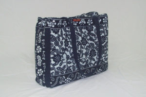 Quilted indigo blue bag with floral patterns, created by Shengzhu Bernardin