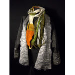 A grey jacket and orange, white, and green scarf by Noriko Iizuka