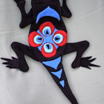 Black cloth frog by Jacquelyn Morgan with a bright red and blue design on his back