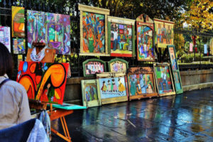 Various Photographs by Joseph Perno on display on a sidewalk