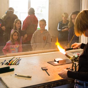 Children observing the process of beadmaking