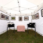 A display showcasing a collection of photography by Dennis Abriola