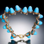A bracelet by Ricky Boscarino of blue pieces kept in joined metal rings clasped together with a lobster hook
