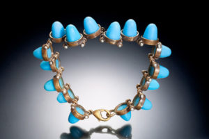 A bracelet by Ricky Boscarino of blue pieces kept in joined metal rings clasped together with a lobster hook