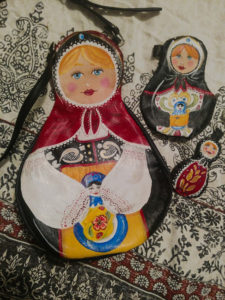 Leather cut and painted to resemble three Russian nesting dolls. Created by Julie Bradley