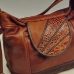 brown leather bag by Clay Rosenbarker