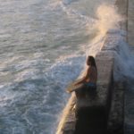 Male body boarder watching waves break