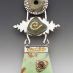 Earth toned necklace by Caryn Hetherston with three tiers, a disc on top, connected to the middle green stone with silver leaves, connected to the bottom jade colored piece