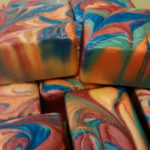 A stack of marbled multicolor soap from Bay Berry Bliss, LLC