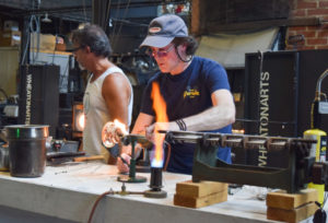 Artist on the Glass Studio floor making a paperweight