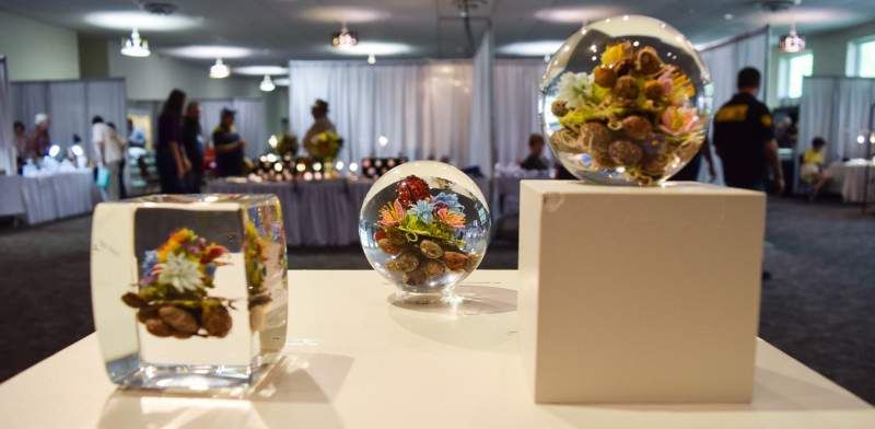 Three floral paperweights by Paul Stankard on display at Paperweight Fest 2016