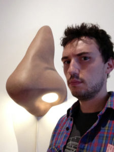 Headshot of Zac Weinberg next to a large depiction of a nose. Symbiotic Spheres exhibiting artist.