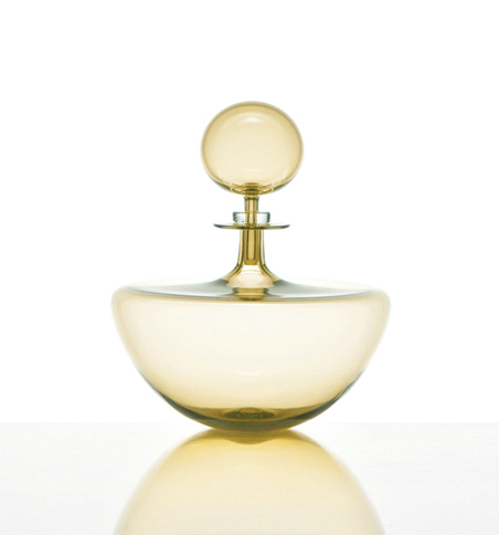 Small golden decanter on a white background and cast reflection. Created by Joe Cariati