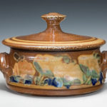 Wide bowl with lid with orange and blue floral designs. Created by Terry Plasket