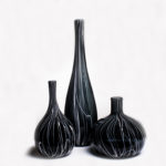 Three black vases, each with white swirls from bottom to top, by Skitch Manion