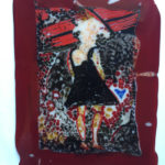 A fused glass depiction of a woman in a black dress with a black background and a maroon frame
