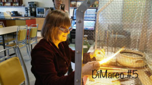 A smiling Deborah DiMarco flameworking