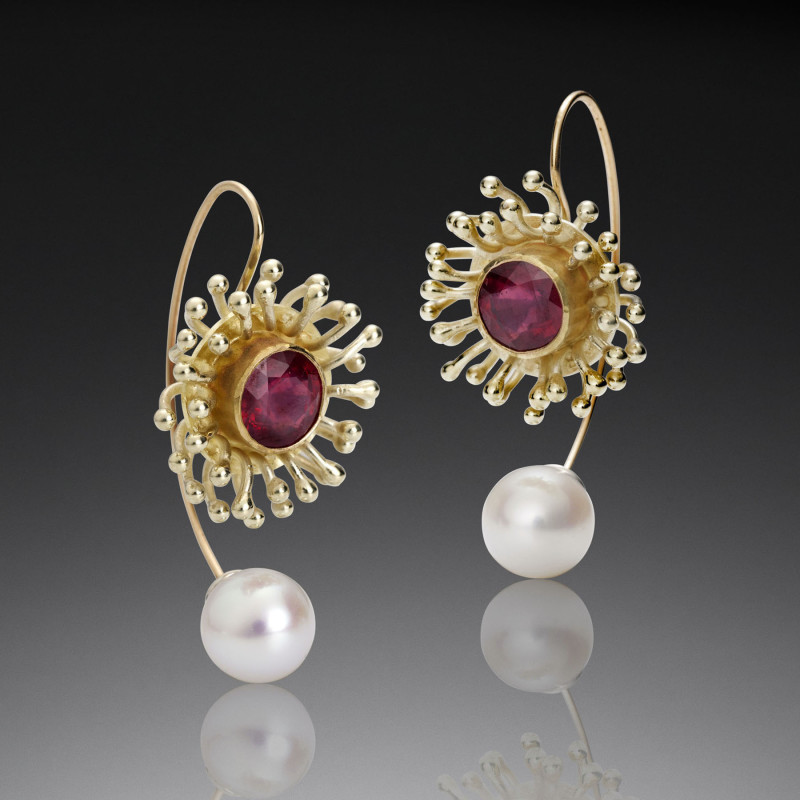 Gold earrings with red gemstone inside anemone shaped bezel and french wire back with pearl base. Created by Samantha Freeman