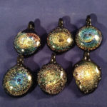 Six glass pendants with swirling golden designs by Bill Futer