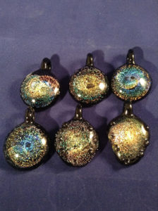 Six glass pendants with swirling golden designs by Bill Futer