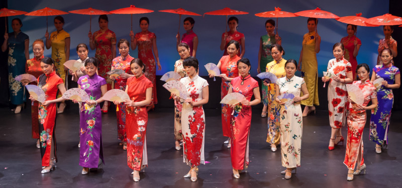 25 gracefully poised Chinese Opera performers arranged in 3 rows