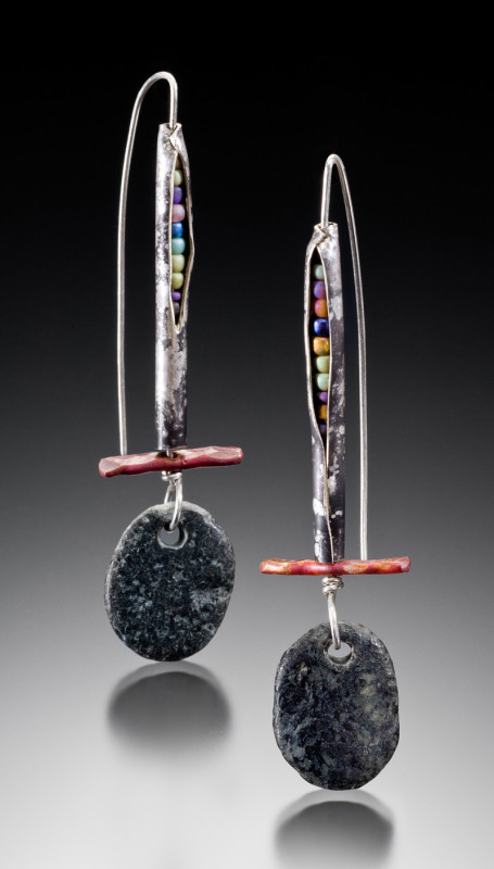 Metal earrings decorated with beads, a red bar at the base and a dangling gray stone created by Marjorie Rawson
