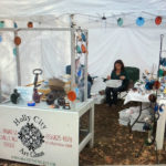 Table displaying the work of James Sharpless, Holly City Art Glass