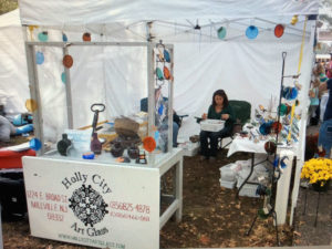Table displaying the work of James Sharpless, Holly City Art Glass