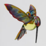 A flamework glass hummingbird with an iridescent body by Thomas Von Koch