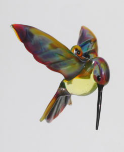 A flamework glass hummingbird with an iridescent body by Thomas Von Koch